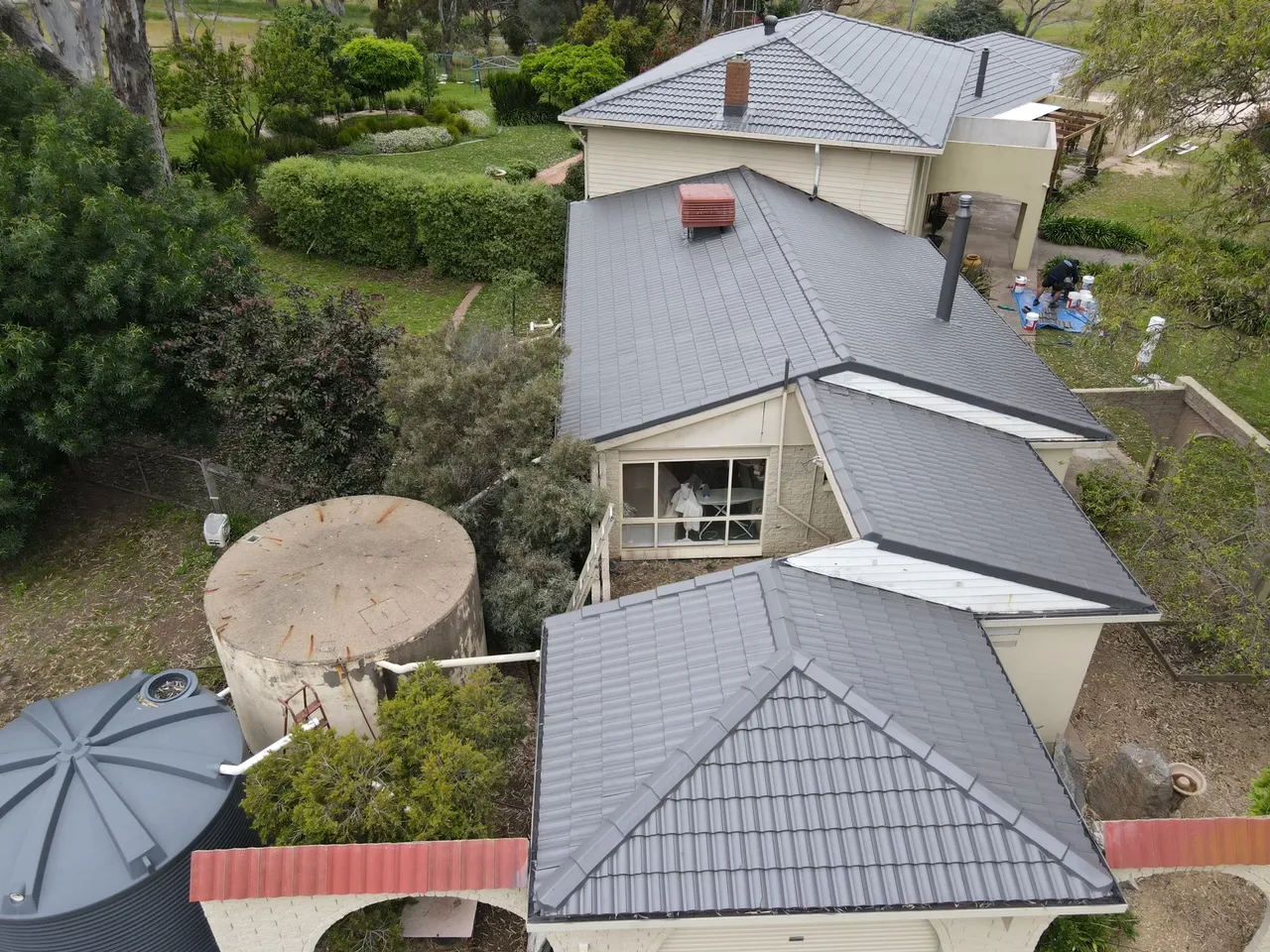 Ridge and hip capping finished in one colour across several sections of a restored concrete tile roof in the Bendigo region